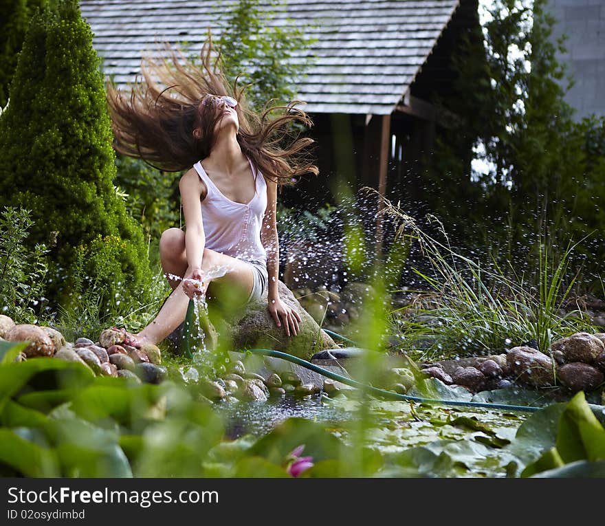 Young Happy Girl With Garden Streamlet Near Pond