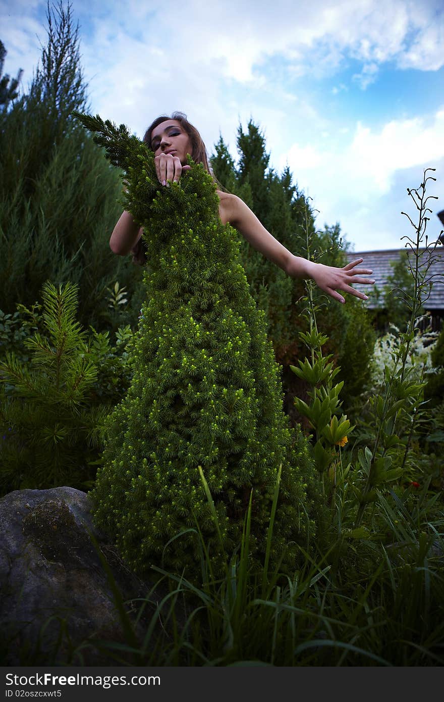 The Girl In A Dress From A Decorative Fur-tree.