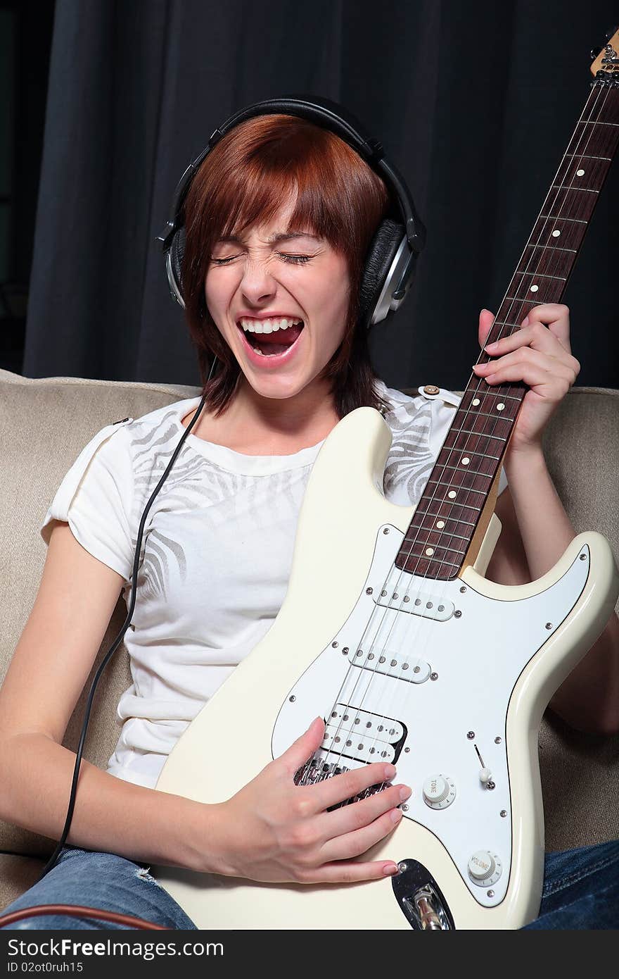 Young woman playing electric guitar