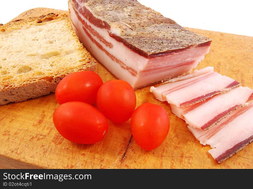 Foreground of bacon and tomato to prepare better a sandwich. Foreground of bacon and tomato to prepare better a sandwich