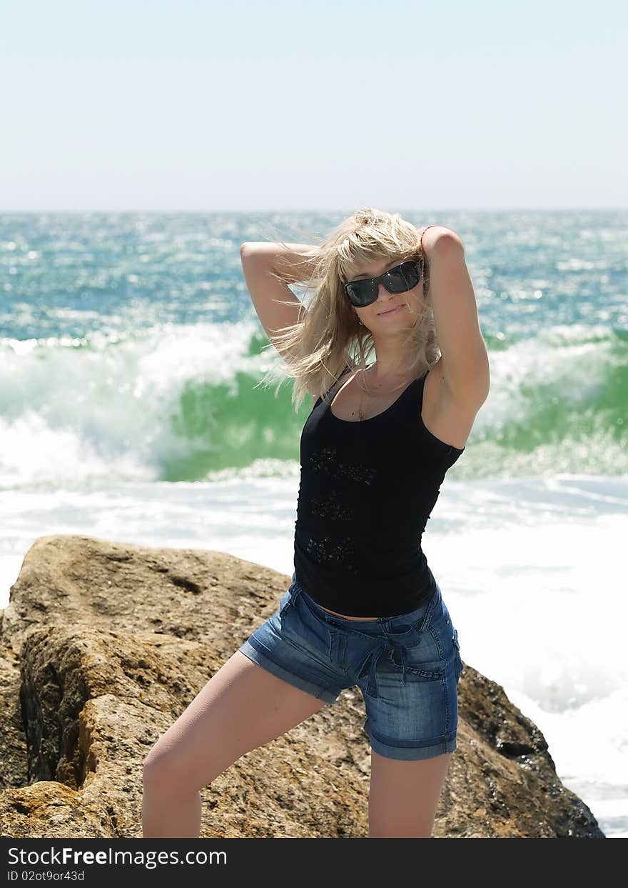 Young blonde woman vacationing at the beach. Young blonde woman vacationing at the beach