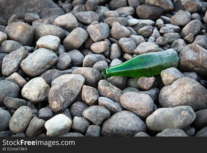 Green bottle by lake