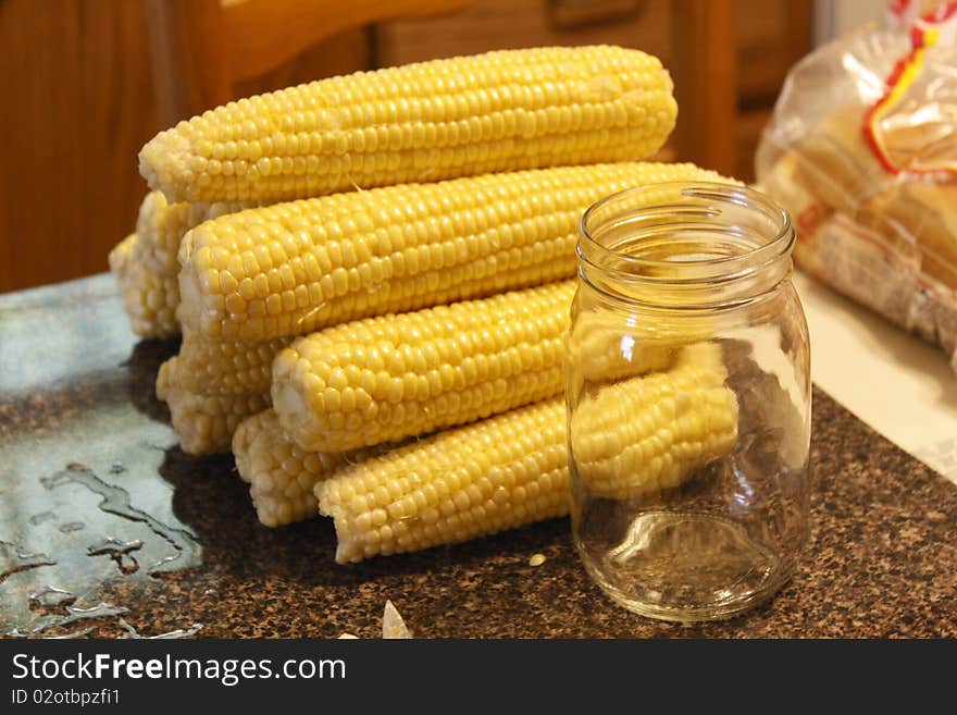 Ears of corn and canning jar