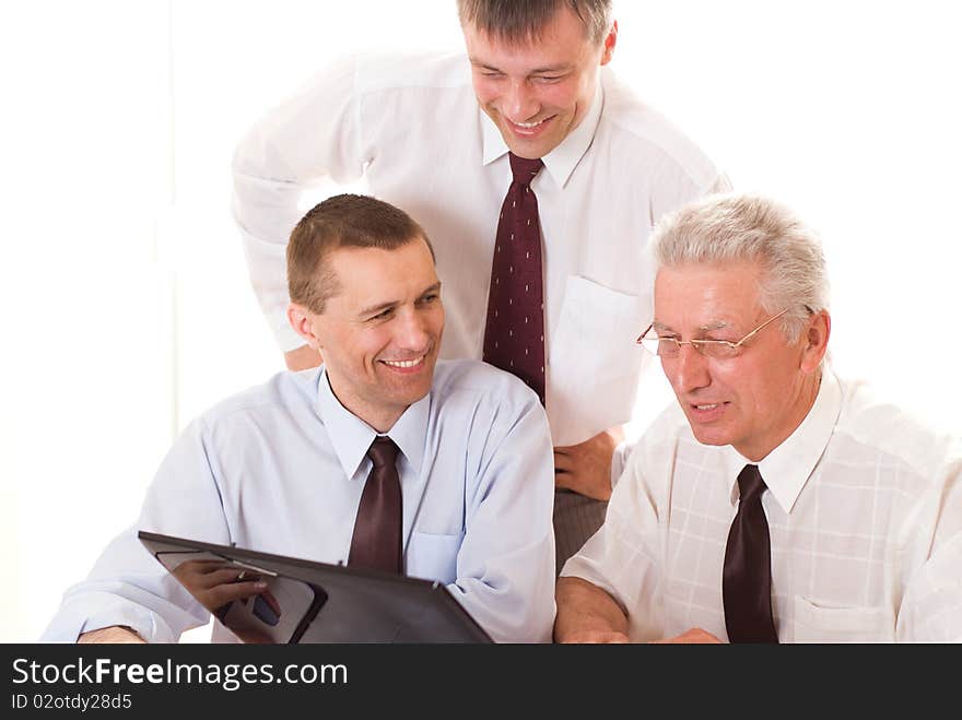 Three businessmen working on a white background. Three businessmen working on a white background