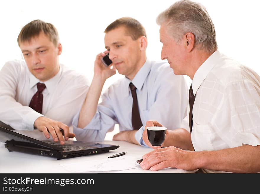 Three businessmen working on a white background. Three businessmen working on a white background