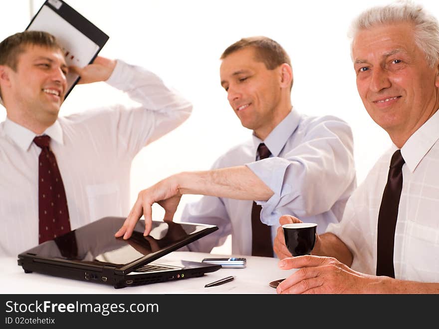 Three businessmen working on a white background