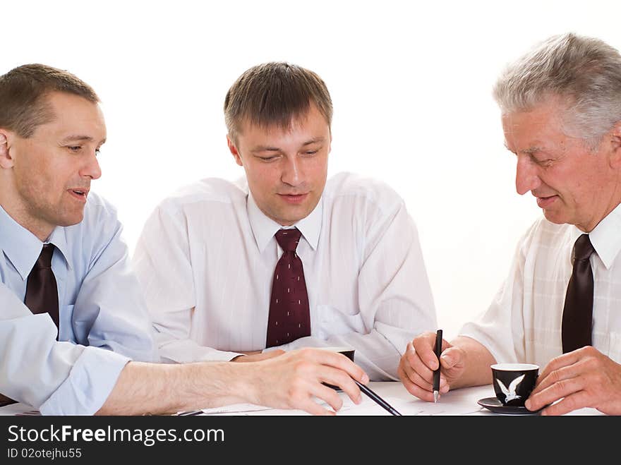 Three businessmen working on a white. Three businessmen working on a white