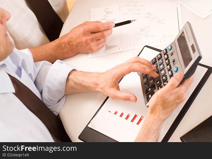 Two businessmen working together on a white