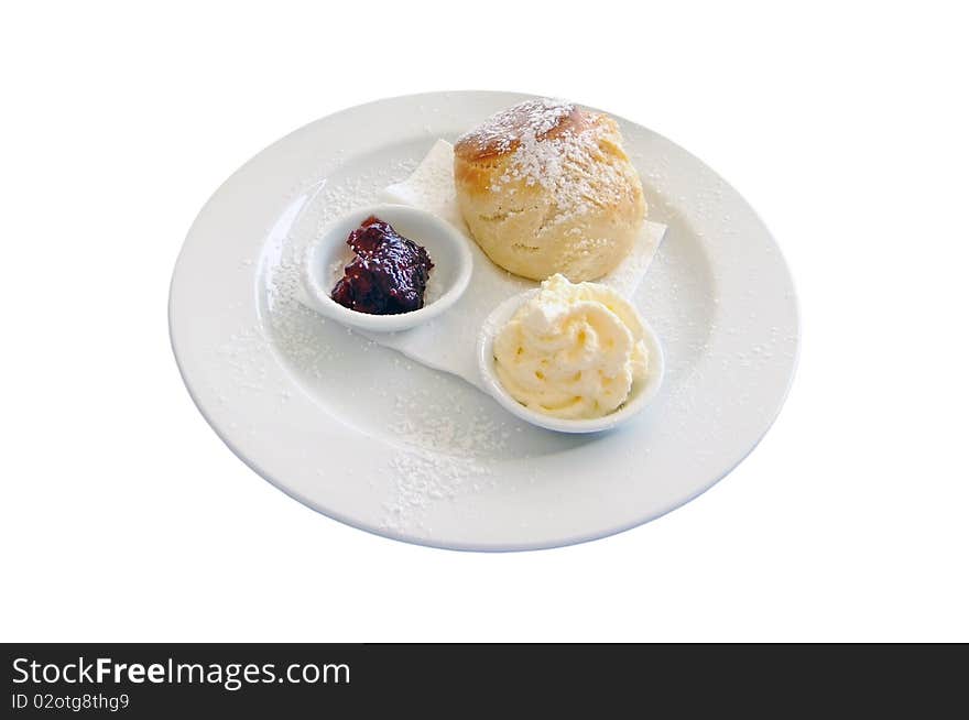 A traditional scone with whipped cream and strawberry jam isolated on white