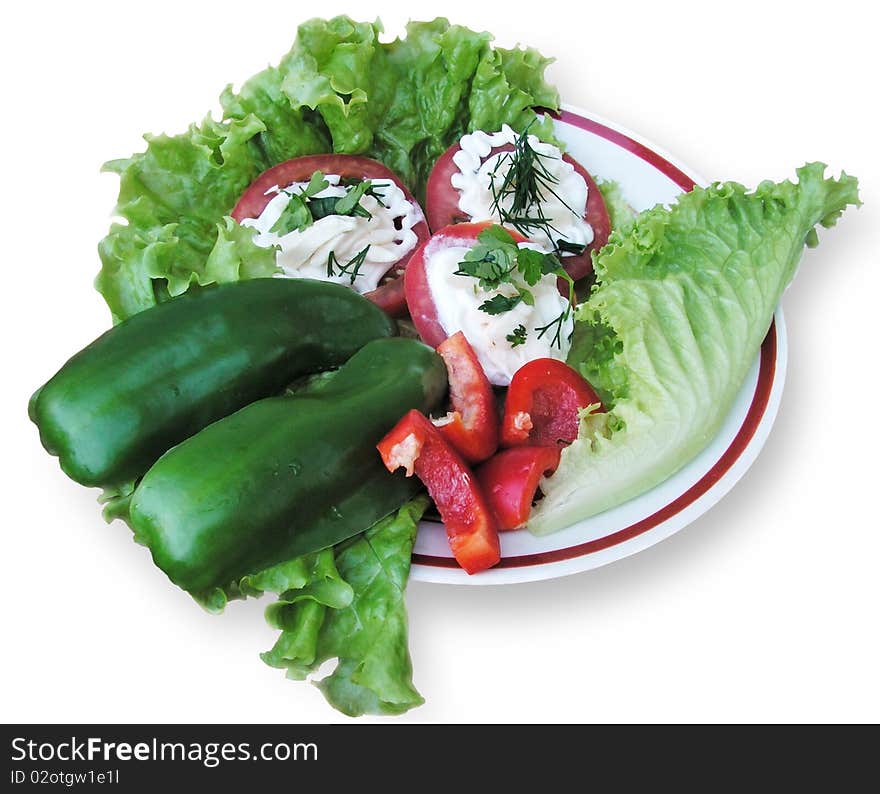 Plate with salad, tomatoes and pepper on a white background