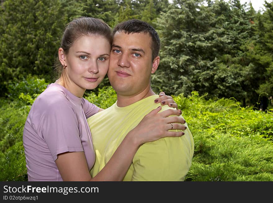 Young couple in the park over defocused background