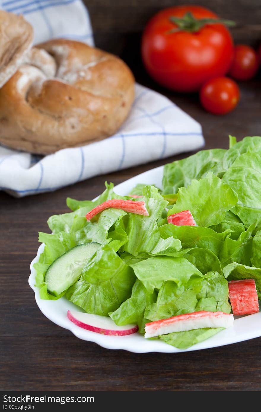 Lettuce salad with crab meat on wooden table top