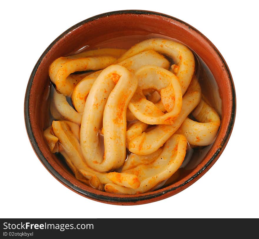 Isolated squid slices with oil in crockery