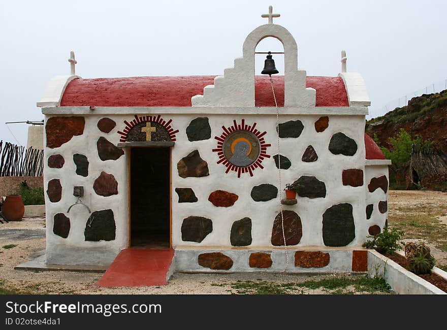 Small greek orthodox church in Crete island, attractive by its walls with colored stones. Small greek orthodox church in Crete island, attractive by its walls with colored stones