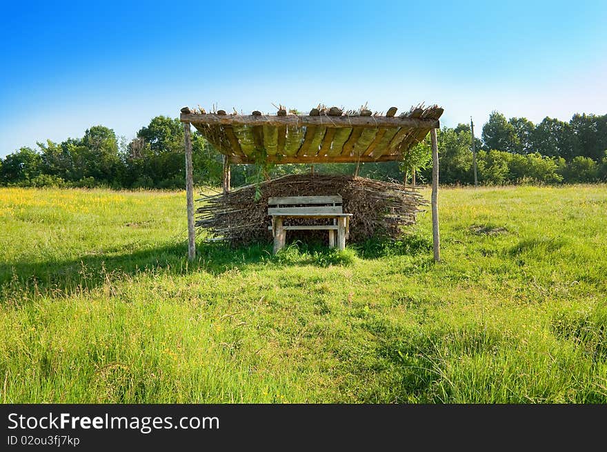 Garden furniture from wood and reeds in the meadow. Garden furniture from wood and reeds in the meadow