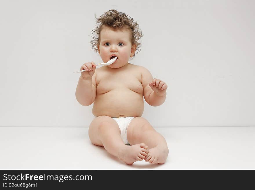 Sitting baby girl on white background