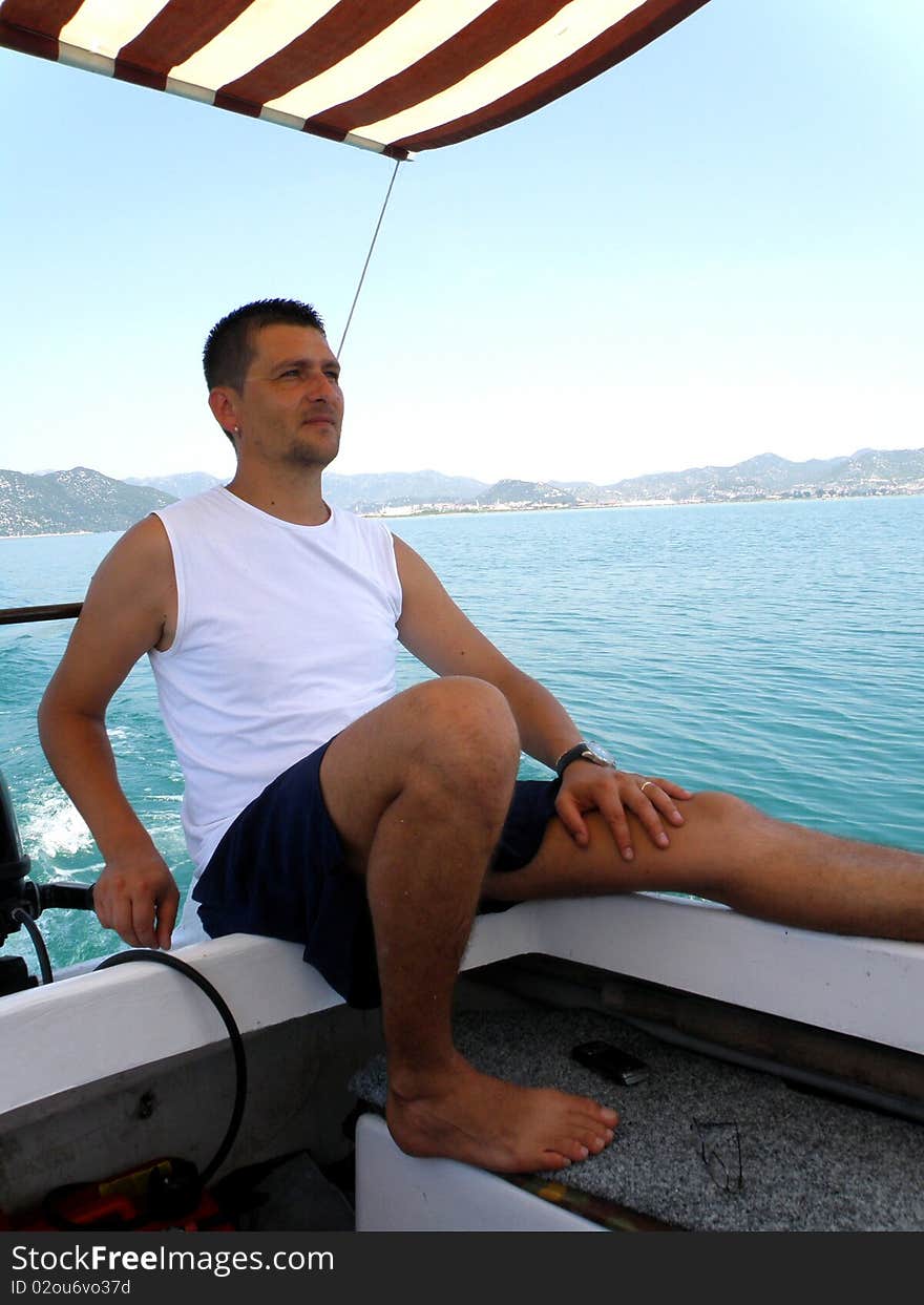 A man driving a boat in the Adriatic Sea