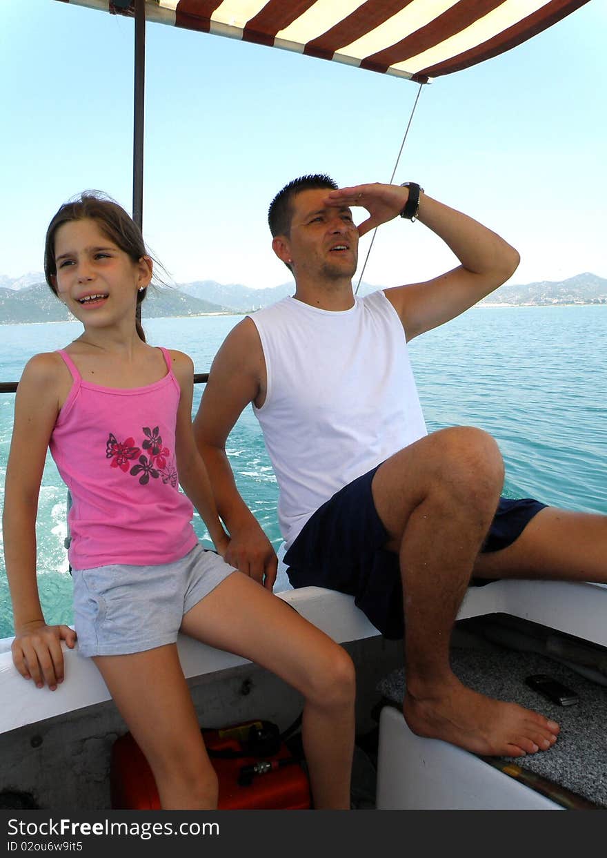 Father and daughter drive the boat