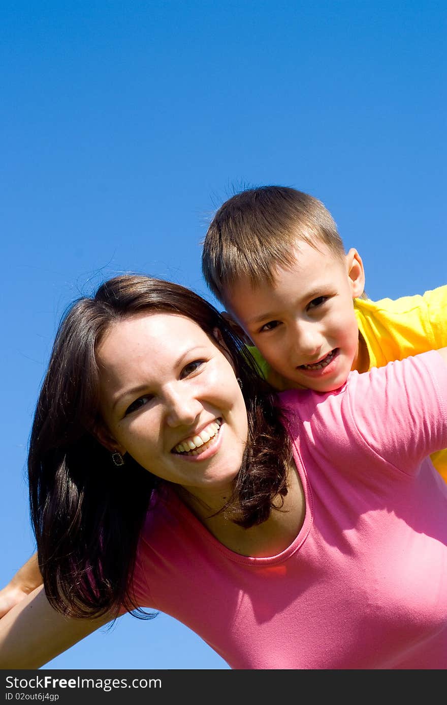 Happy woman  with  son on a background of sky