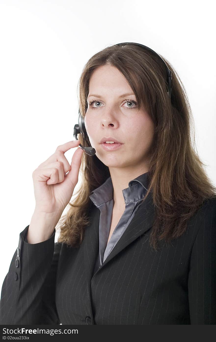 Young woman working at a helpdesk wearing headset. Young woman working at a helpdesk wearing headset