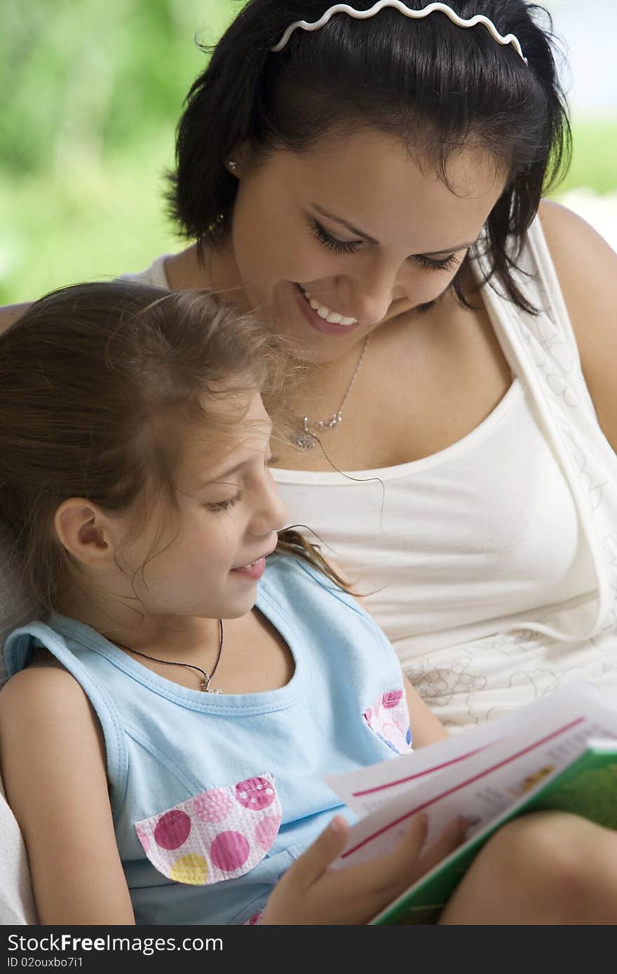 Portrait of happy mother with daughter having good time in summer environment. Portrait of happy mother with daughter having good time in summer environment