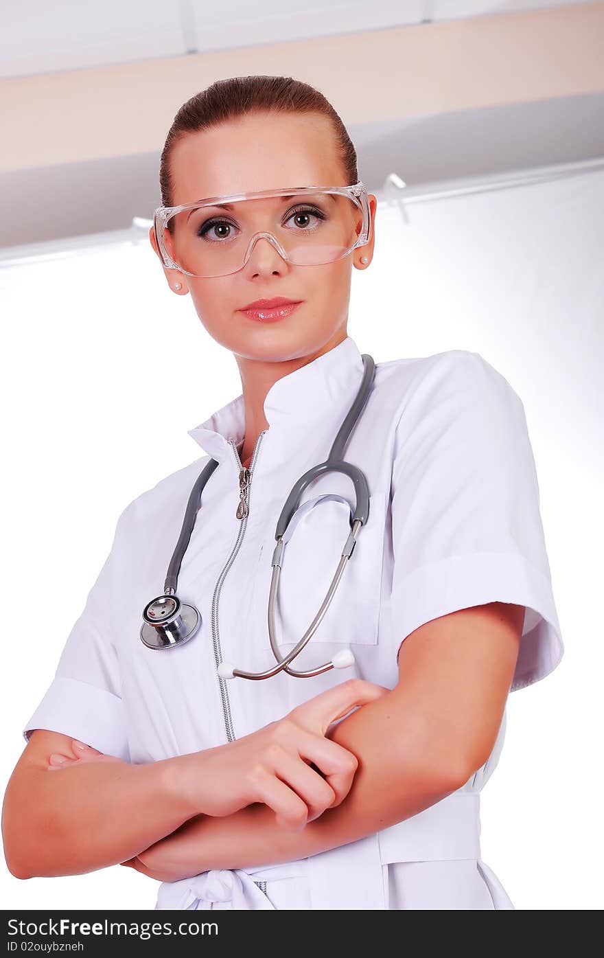 Young nurse in white uniform, transparent glasses and a stethoscope