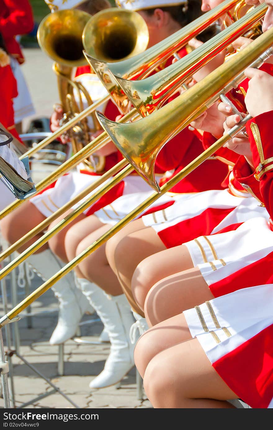 Girl Brass Band in red uniform performing