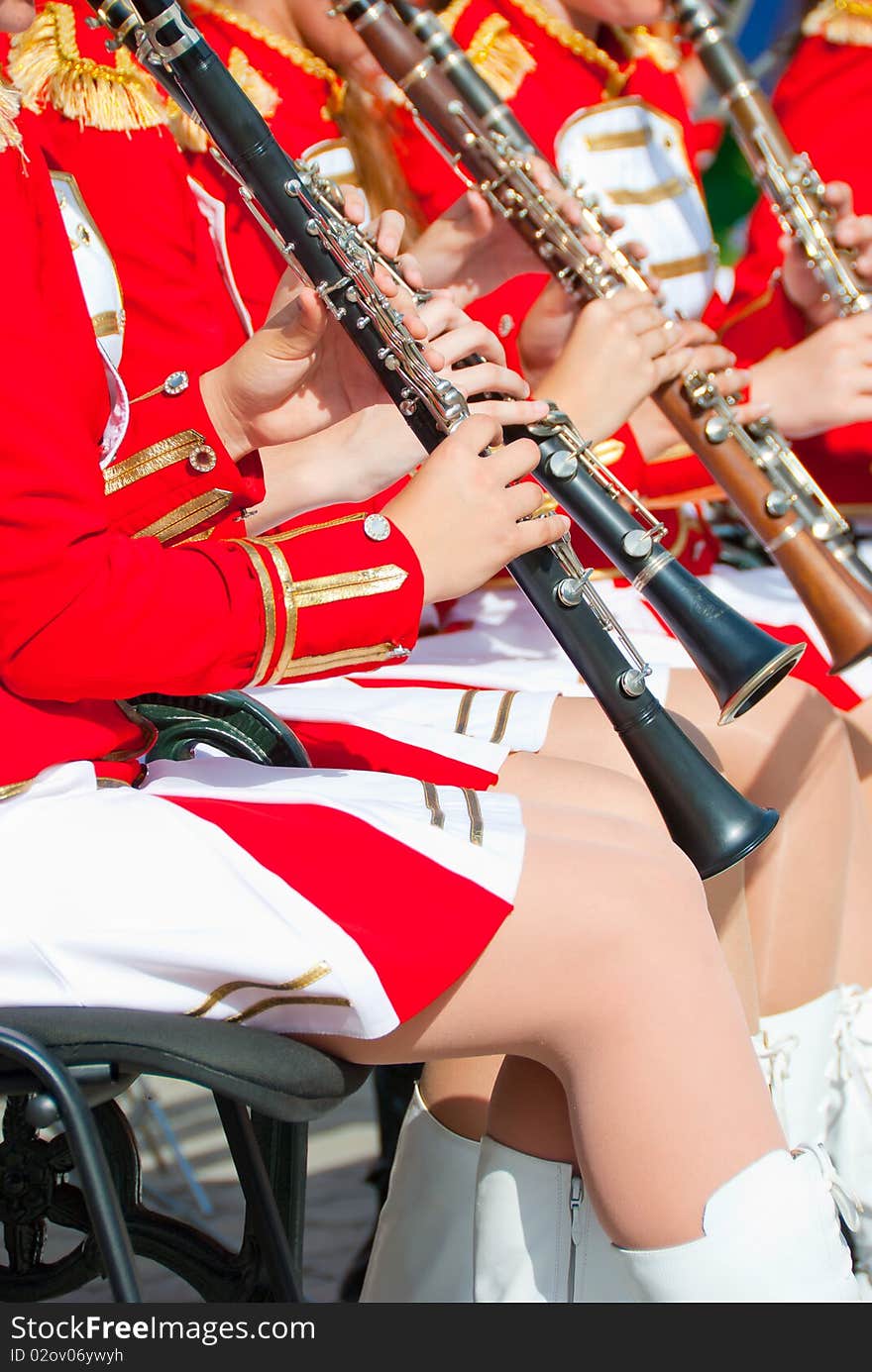 Girl Brass Band in red uniform performing