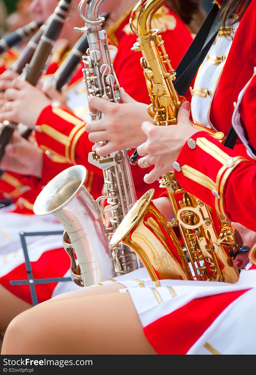 Girl Brass Band in red uniform performing