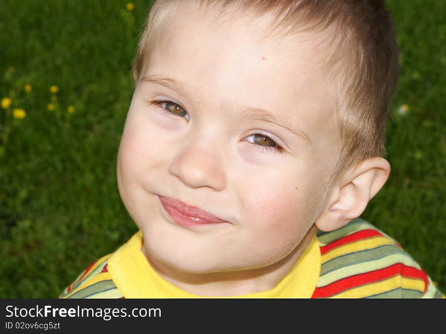 A smiling child looks into the camera, portrait