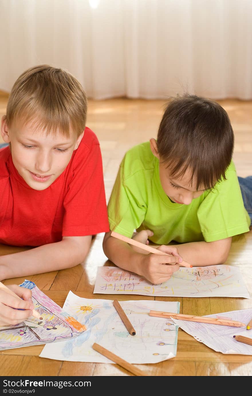 Brothers lying on the floor and draw. Brothers lying on the floor and draw