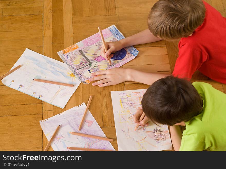 Brothers lying on the floor and draw. Brothers lying on the floor and draw