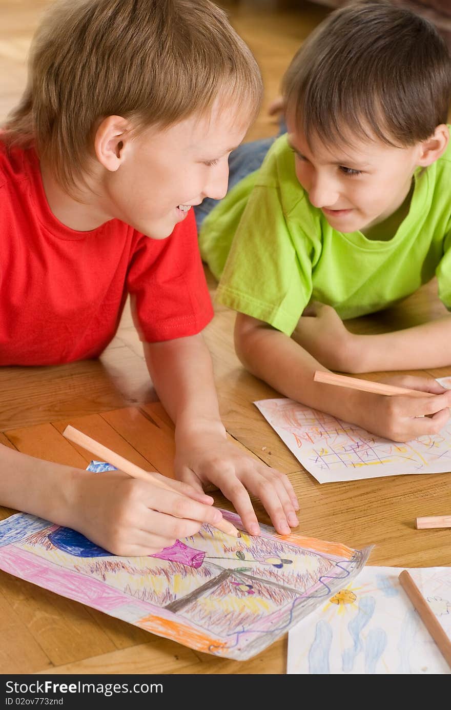 Two brothers lying on the floor and draw. Two brothers lying on the floor and draw