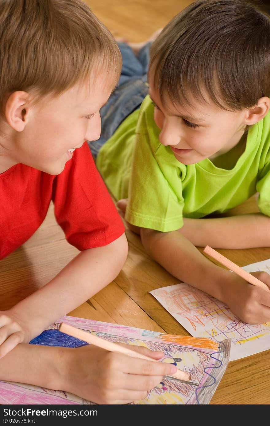 Brothers lying on the floor and draw. Brothers lying on the floor and draw