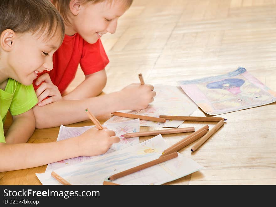 Two brothers lying on the floor and draw. Two brothers lying on the floor and draw