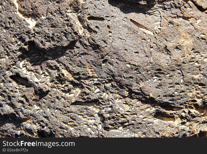 The black volcanic stone background texture. The black volcanic stone background texture.