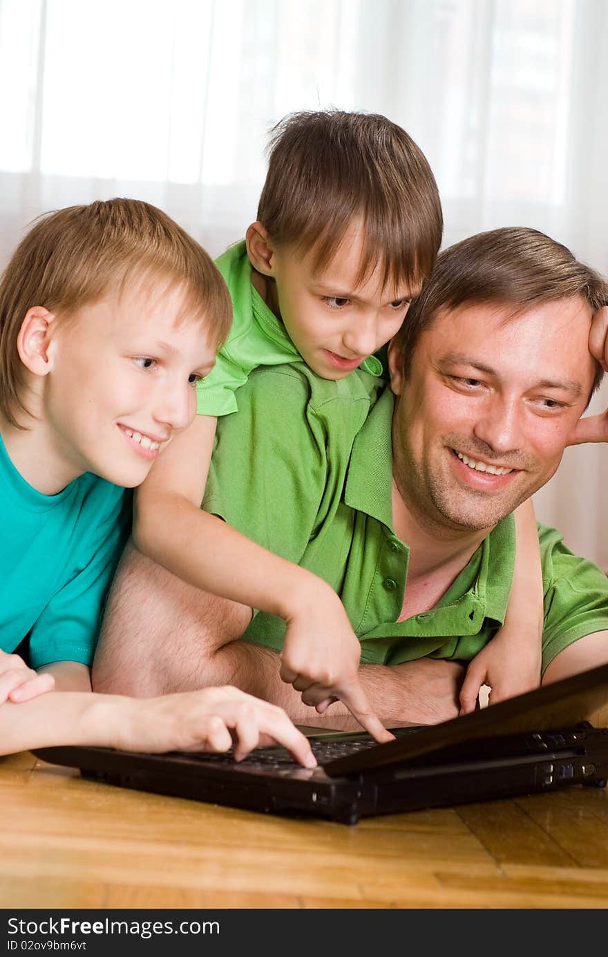 Father with his sons is with laptop