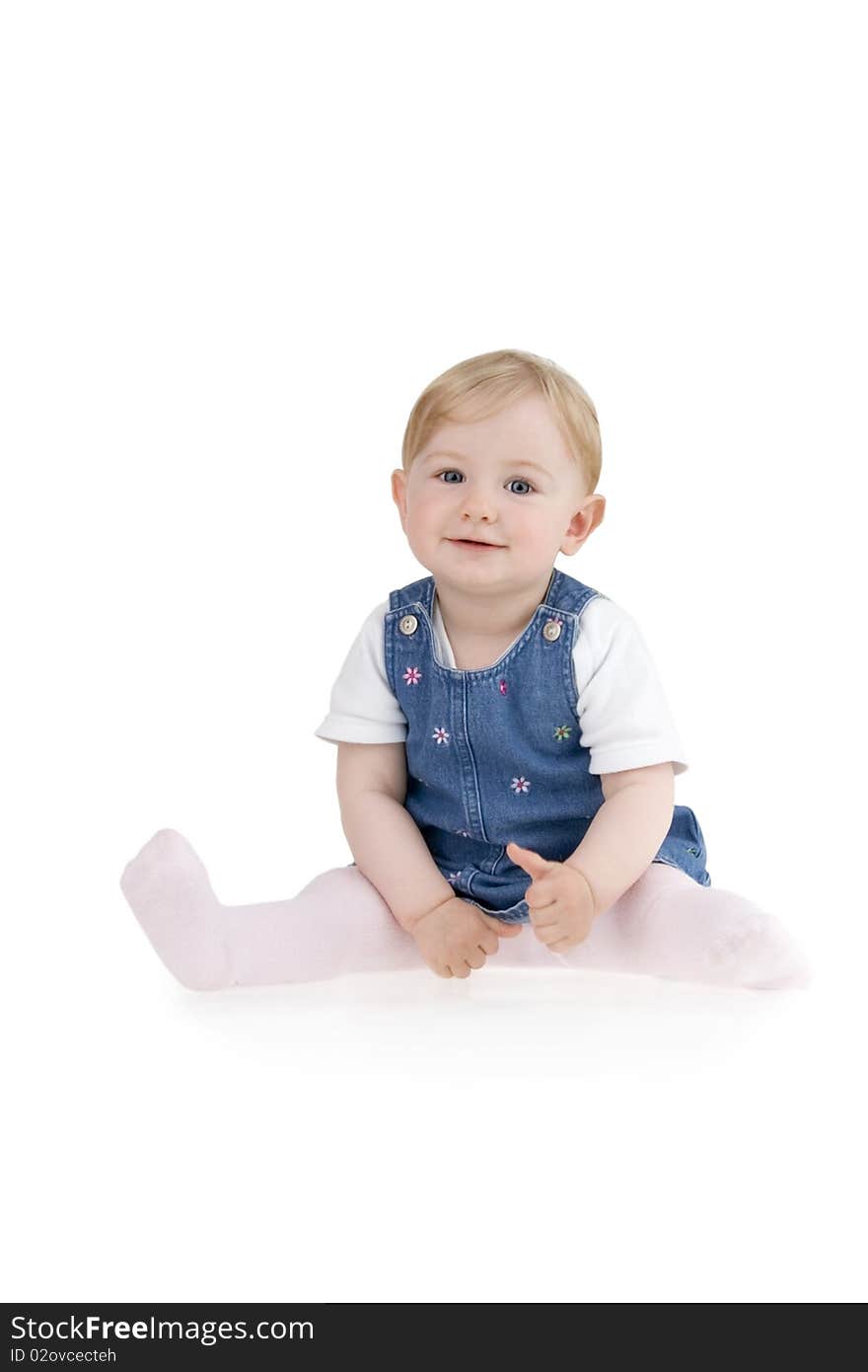 Dinky little girl sitting on white background.