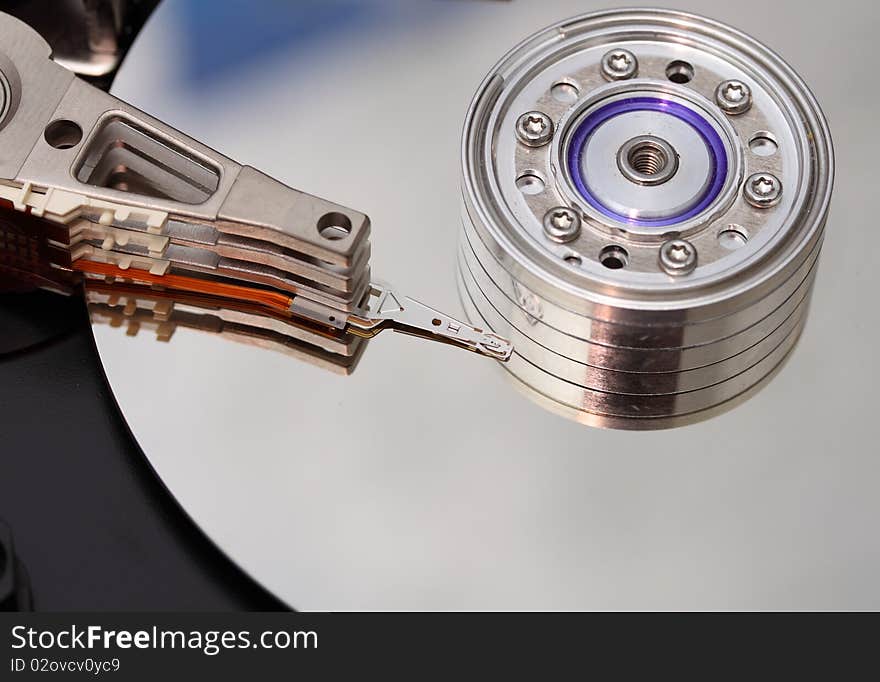 Hard disk. The head reading information from a surface of a hard disk.