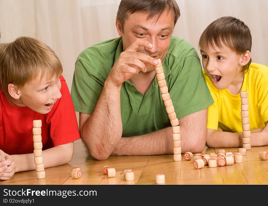 Happy father with children playing on the floor