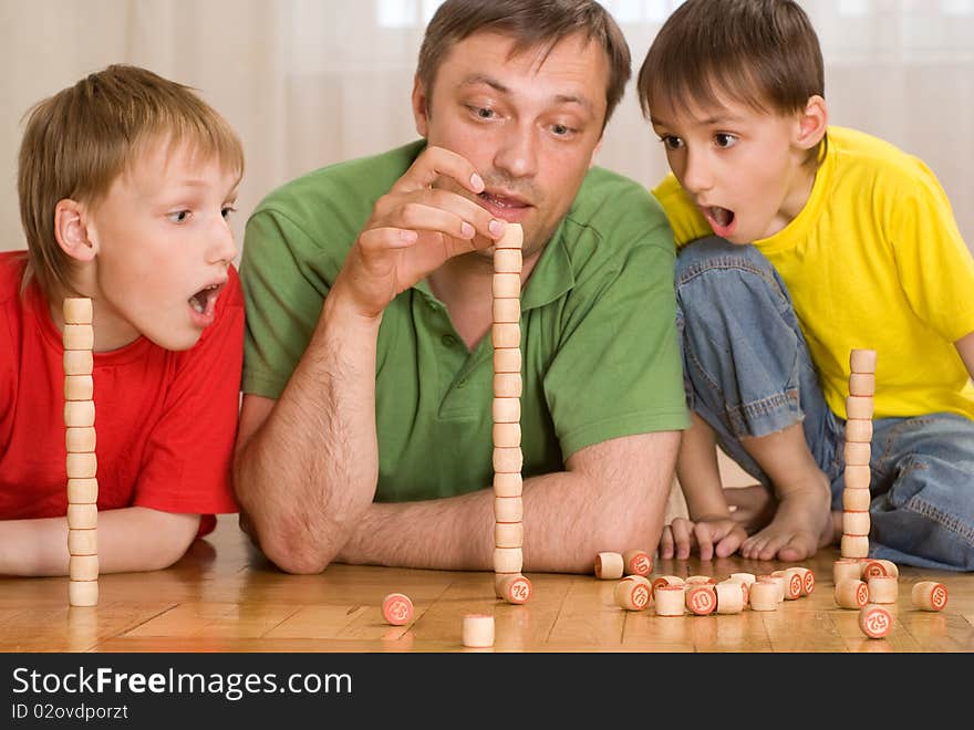 Happy father with children playing on the floor