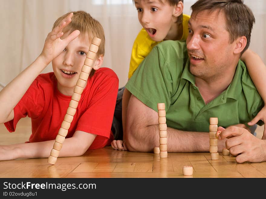 Happy father with children playing on the floor