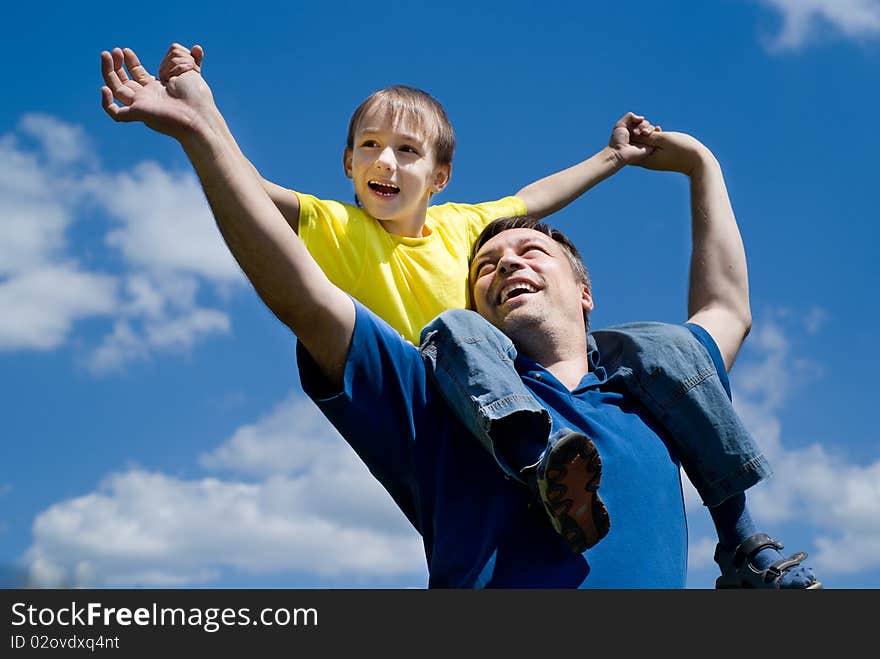 Happy father with his son on a background of sky