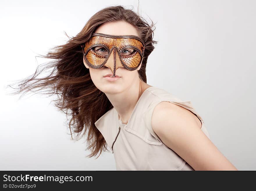 Young beautiful girl with the Venetian mask