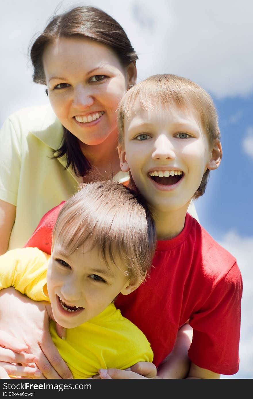 Happy boys with mom in the summer park