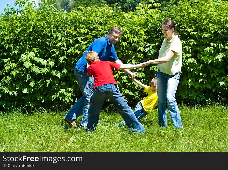 Happy boys with family in the summer park