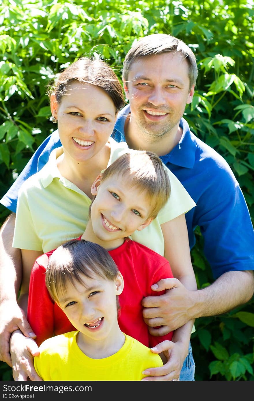 Happy family of four on the nature