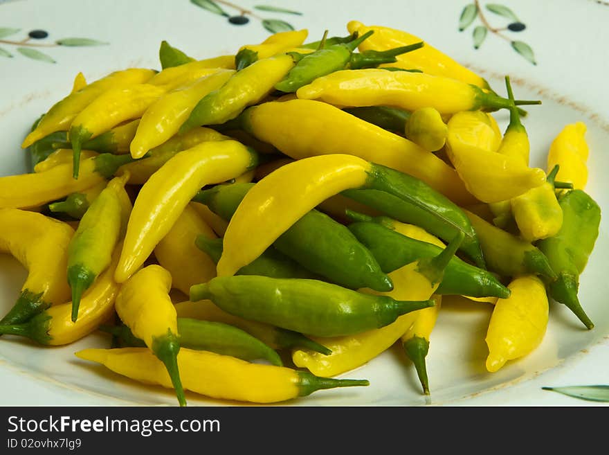 Green and yellow chilis on a plate