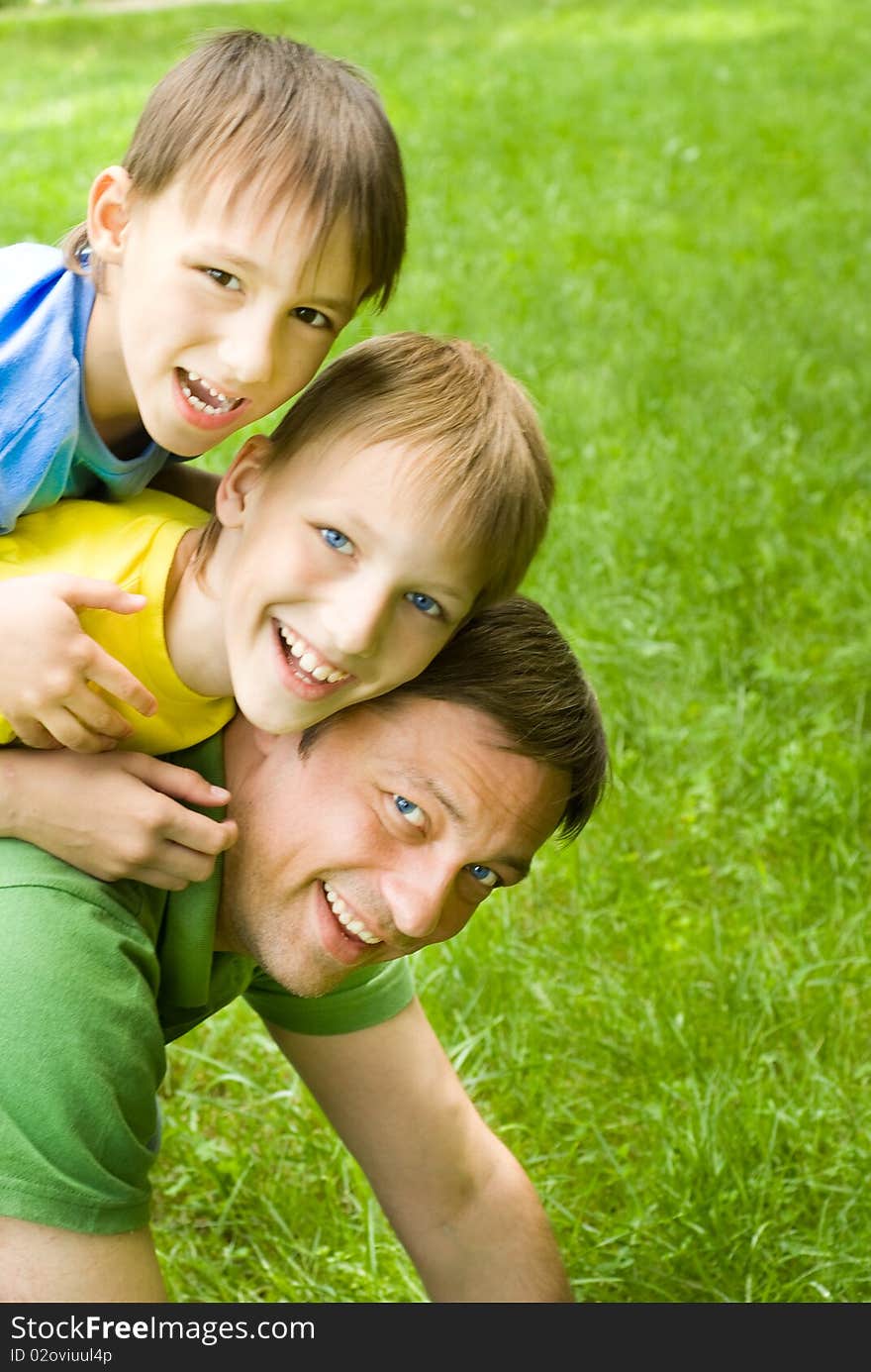 Smiling father resting with boys