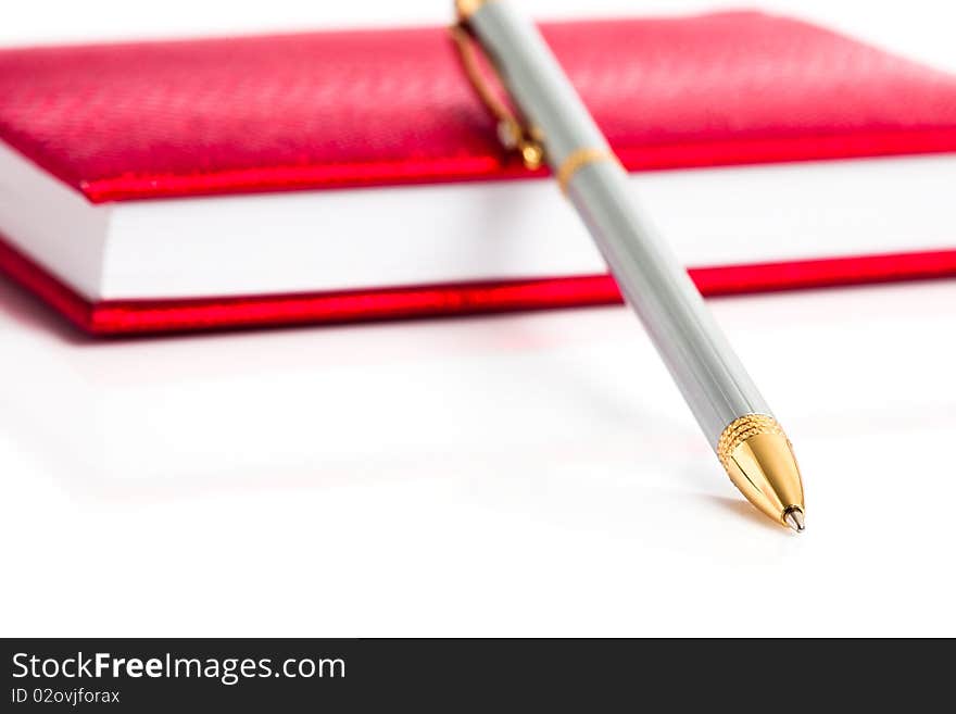 Red notebook with silver pen